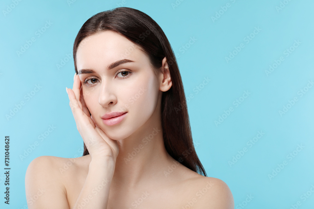 Portrait of beautiful young woman on light blue background. Space for text Portrait of beautiful young woman on light blue background. Space for text