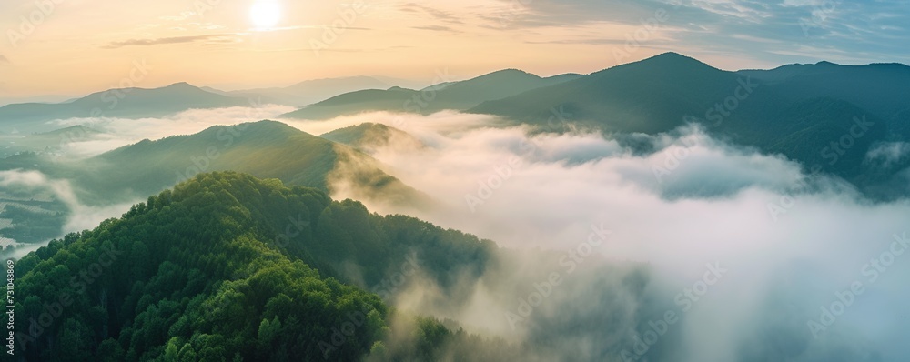 panorama of the sea of clouds around the mountain peak with green trees and fresh air at sunrise - obrazy, fototapety, plakaty 