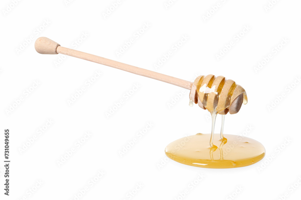 Natural honey dripping from dipper on white background Natural honey dripping from dipper on white background