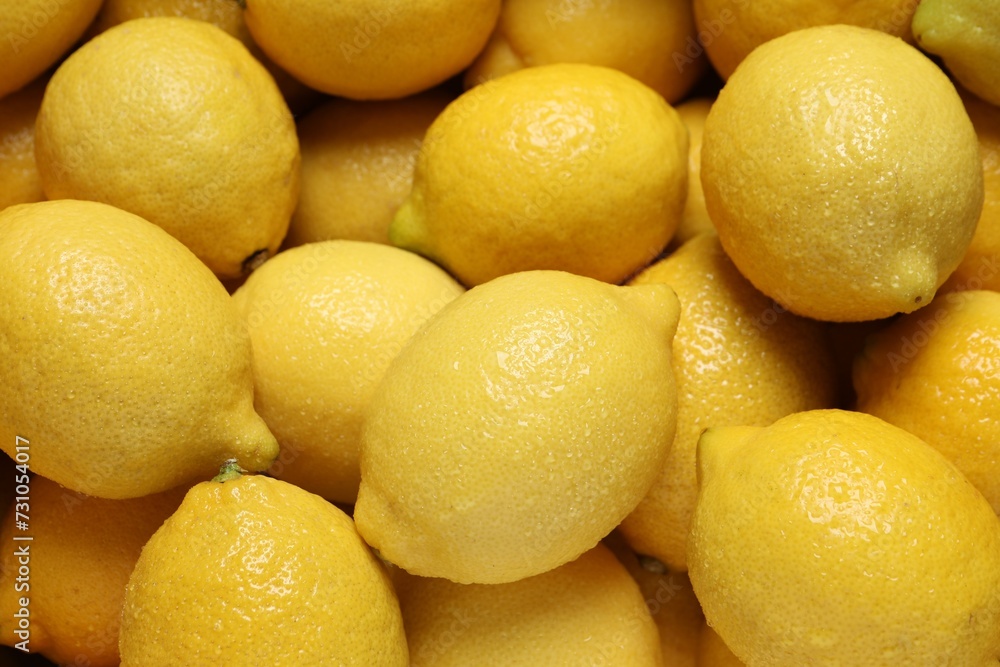 Fresh lemons with water drops as background, closeup Fresh lemons with water drops as background, closeup