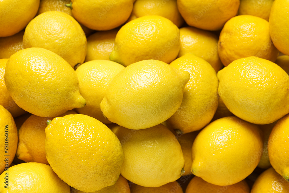 Fresh lemons as background, closeup. Citrus fruit