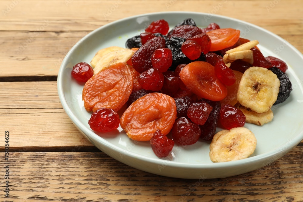 Mix of delicious dried fruits on wooden table, closeup Mix of delicious dried fruits on wooden table, closeup