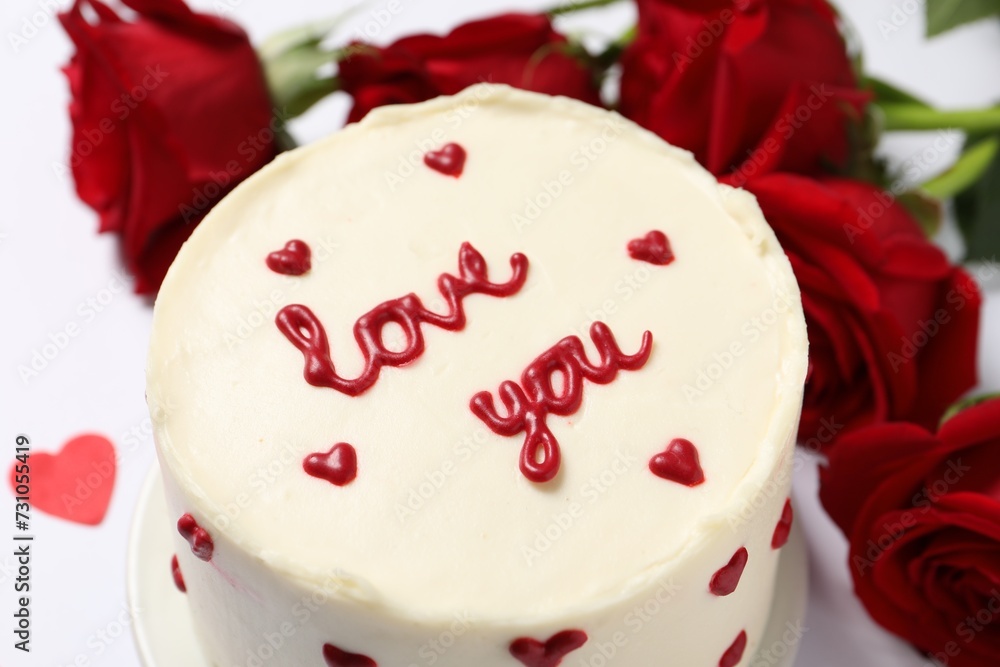Bento cake with text Love You and roses on white table, closeup. St. Valentine's day surprise Bento cake with text Love You and roses on white table, closeup. St. Valentine's day surprise