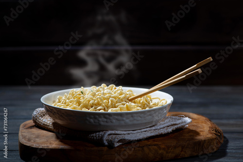 hot noodles in a bowl and chopsticks