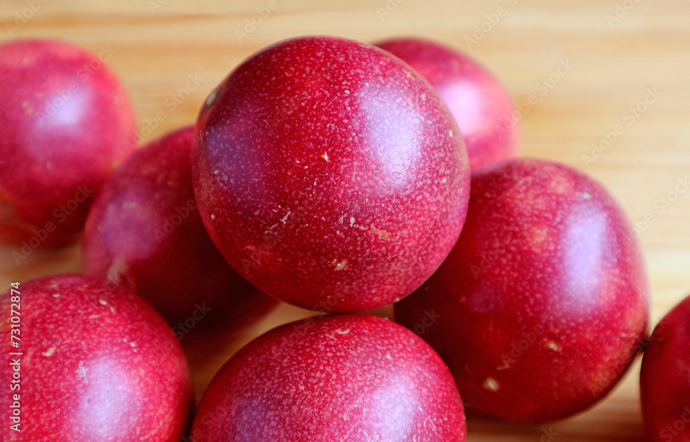 Pile of Fresh Ripe Passion Fruits on Wooden Background Pile of Fresh Ripe Passion Fruits on Wooden Background