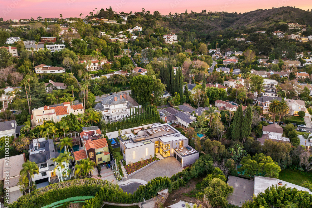 Aerial shot of houses and hills at sunset