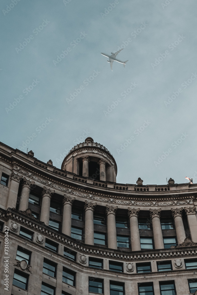 Obraz premium building with plane overhead