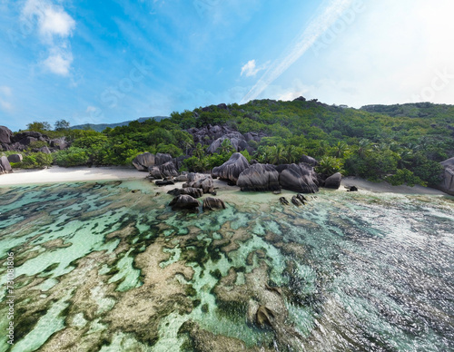 Aerial view of world famous Anse Source d'Argent beach with coral reef and granite boulders