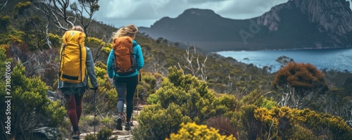 Adventurous, active women embrace Tasmania's untamed beauty through exhilarating bushwalking, exploring the wild. photo