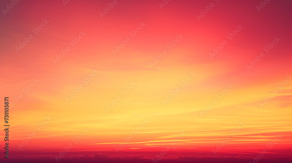 A breathtaking vibrant red and orange sunset sky, blending smoothly into the horizon with soft cloud silhouettes.