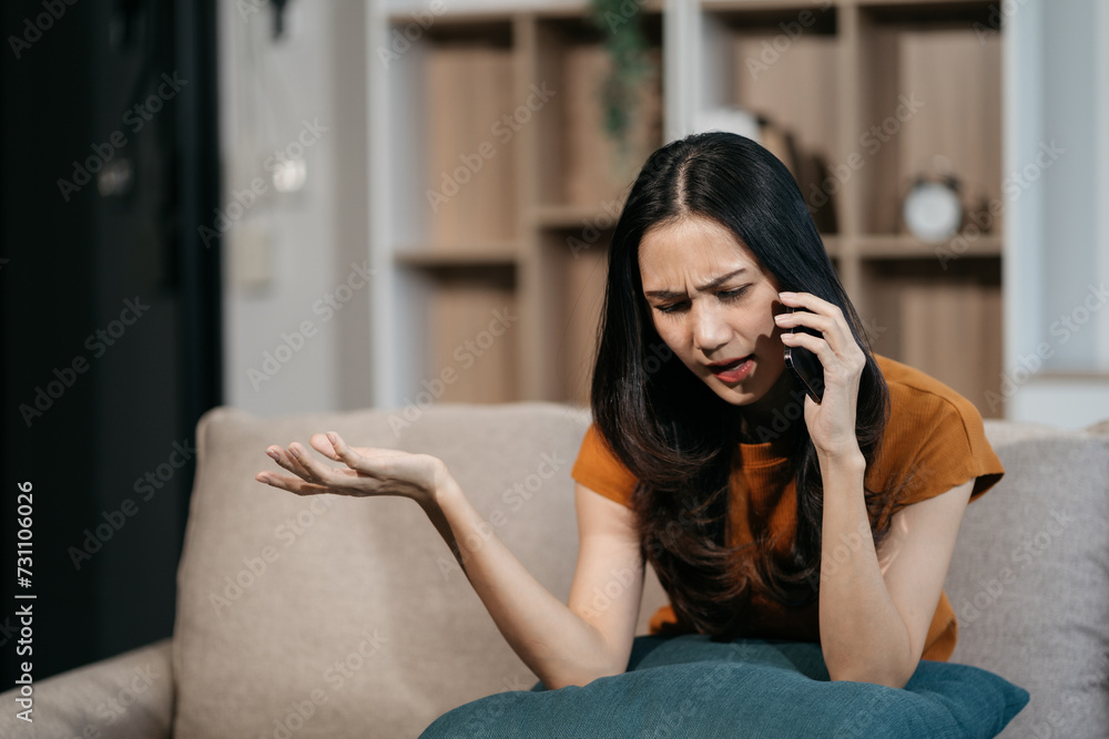 Fototapeta premium Woman talking on the phone arguing laptop computer problems highlighting customer dissatisfaction.