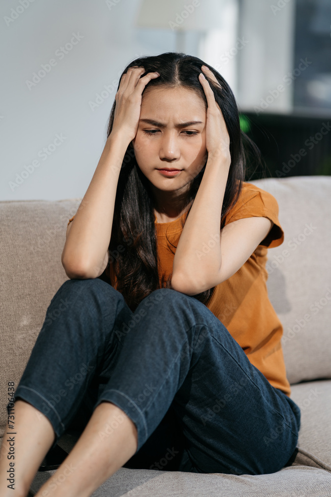 Sad and depressed young female sitting on the sofa, sad mood, feel tired, lonely and unhappy concept. Sad and depressed young female sitting on the sofa, sad mood, feel tired, lonely and unhappy concept.