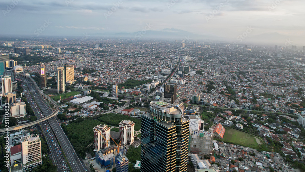 Obraz premium Panoramic cityscape of Indonesia capital city Jakarta at sunset. A rare clear day in the polluted city.