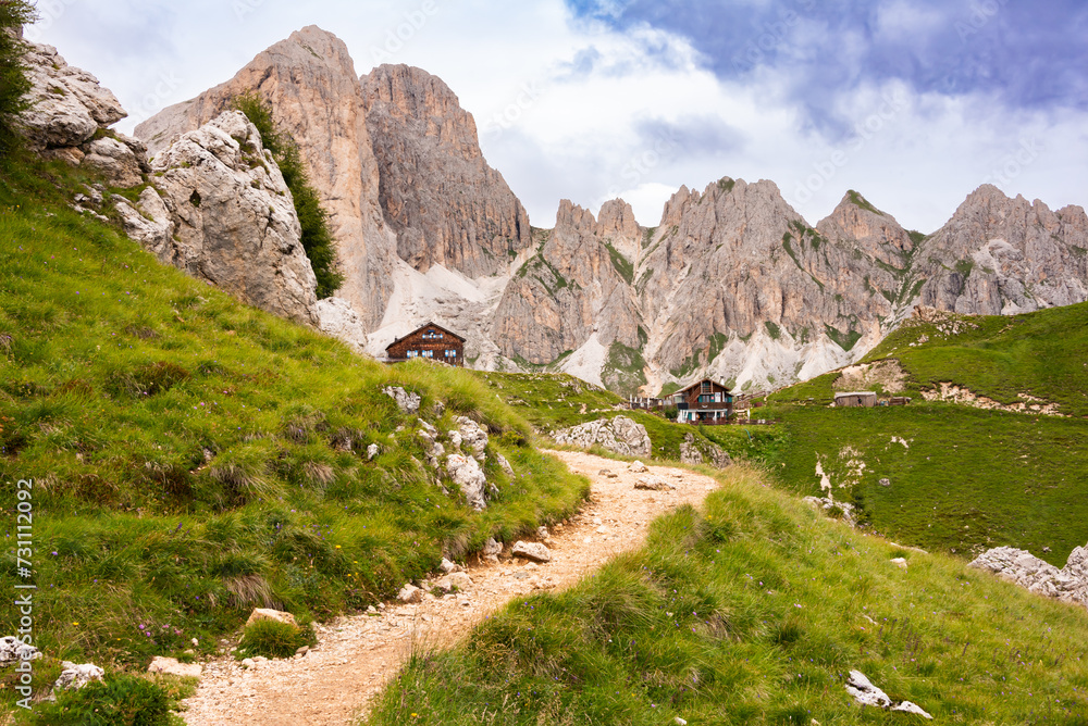 Mountain hiking trail with people walking in Dolomite alps