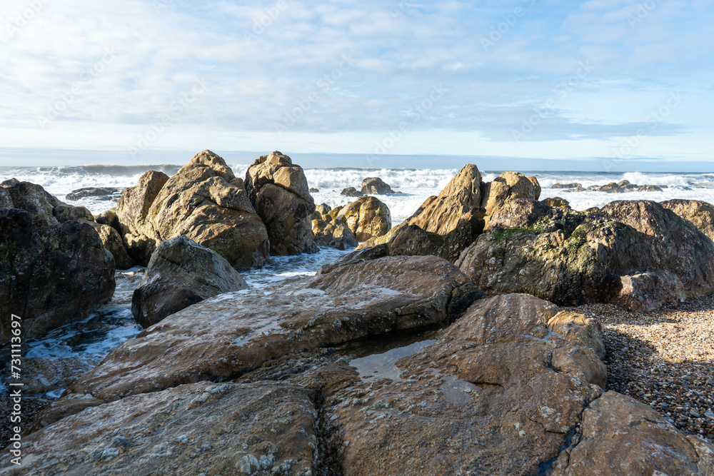 Rocks on the beach and sea waves on a sunny day in Porto, Portugal. Rocks on the beach and sea waves on a sunny day in Porto, Portugal.