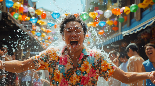 Close up happy Young man having fun on playing water During the Songkran Festival on Khaosan Road, Bangkok, Thailand © supaporn28
