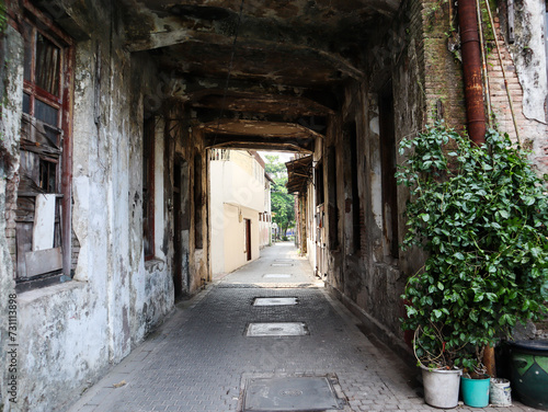 an alley with a small tunnel leading to the street. surabaya  indonesia - 4 january 2024