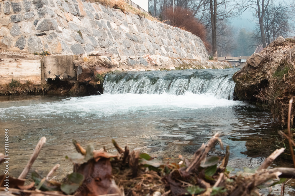 Small waterfall on river dam in public park Small waterfall on river dam in public park