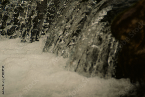 Small waterfall on river dam in public park