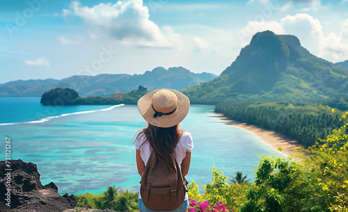 Woman traveler with backpack and hat looking at beautiful view of tropical island.Wellness Travel,Wellness Tourism,Wellness Nature,Relax and Wellness Holidays Concept. © Emmy Ljs
