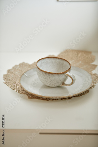 Rustic cup and saucer on lace doily