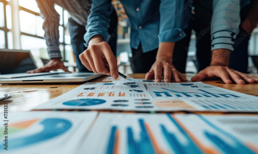 young business man hand holding pen and partner pointing graph chart for analyze the company's sales plan in the office.Generative AI young business man hand holding pen and partner pointing graph chart for analyze the company's sales plan in the office.Generative AI