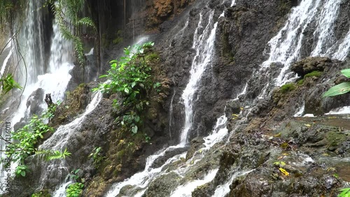 Goa Tetes waterfall. Many streams flow over the stones against the backdrop of beautiful nature. Lumajang Province, East Java, Indonesia photo