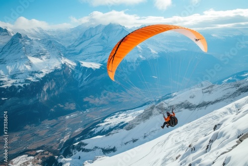 Person Paragliding Over Snow-Covered Mountain