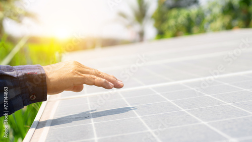 Close up of an young engineer hand is checking an operation of sun and cleanliness of photovoltaic solar panels. smart farming concept, Water system technology in solar energy agriculture. photo