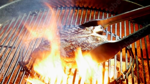 Fiorentina T-bone steak cooking on the barbecue grill photo