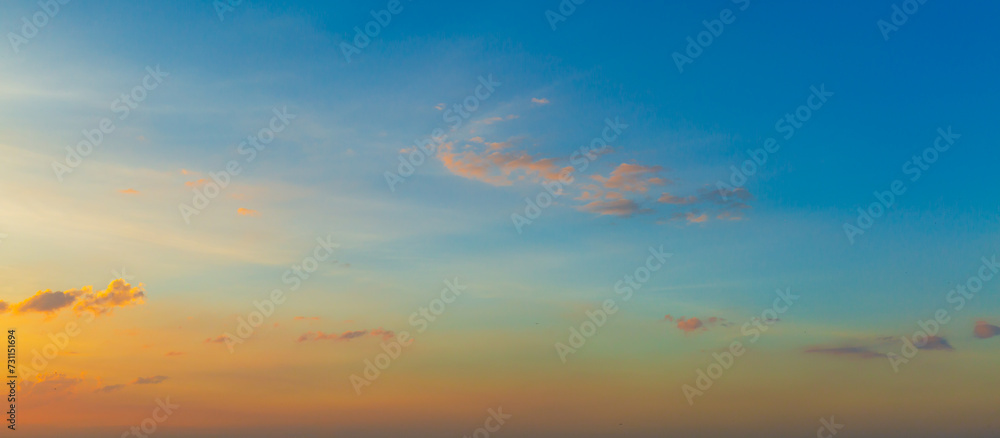 Beautiful Vivid sky painted by the sun leaving bright golden shades.Dense clouds in twilight sky in winter evening.Image of cloud sky on evening time.Evening Vivid sky with clouds