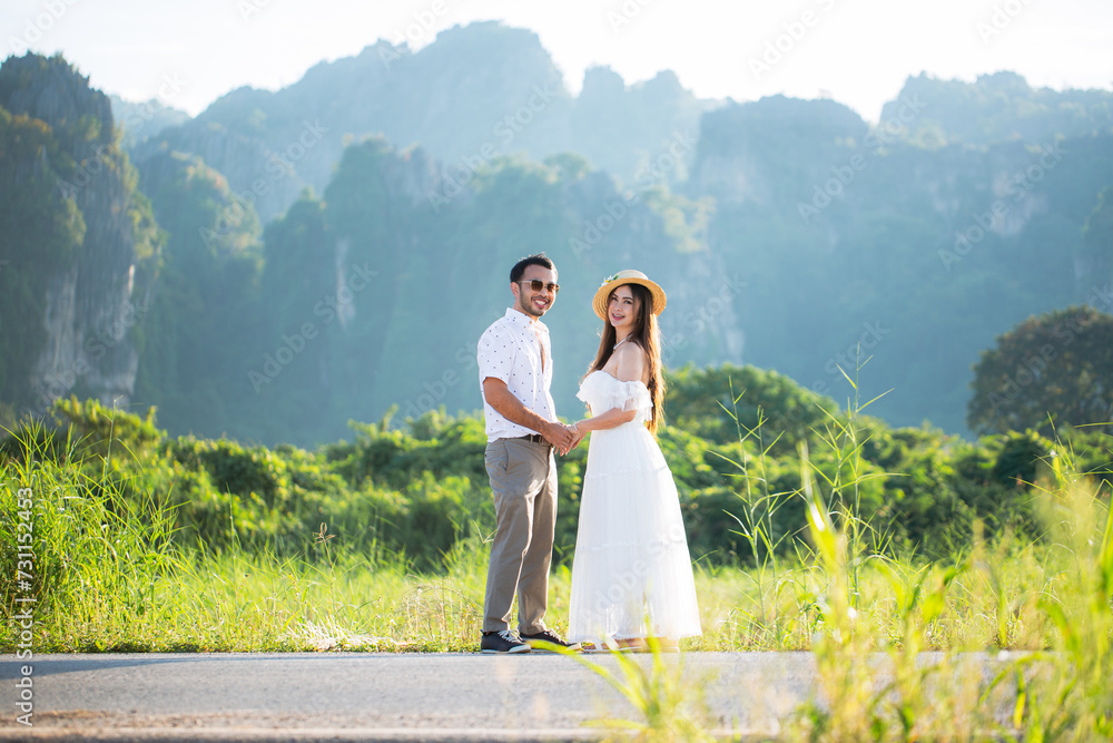Young couple surrounded by mountains and nature,Young couple proposes marriage,Surrounding stunning scenery with views of mountains and valleys.