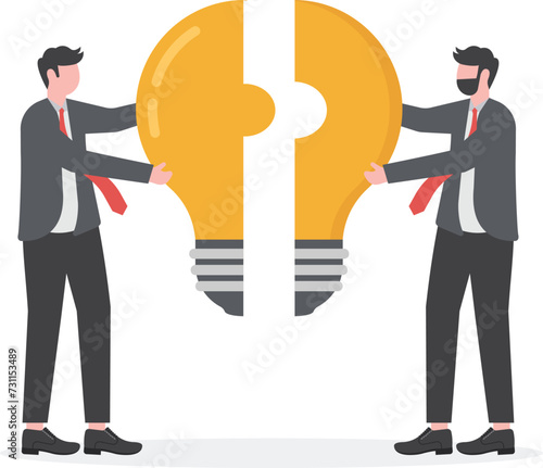 Business metaphor of a joint venture, partnership or teamwork. busines man putting together light bulb shaped puzzle.


