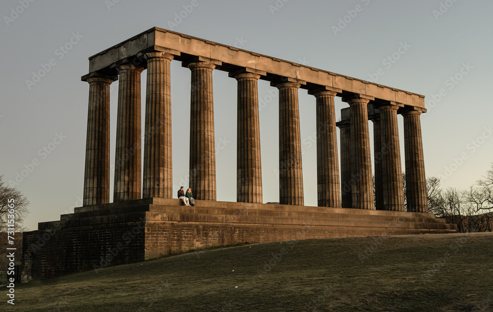 A view of the National Monument of Scotland with a bright blue sky in the background situated on Calton Hill at Edinburgh city. Scotland, Space for text, Selective focus.