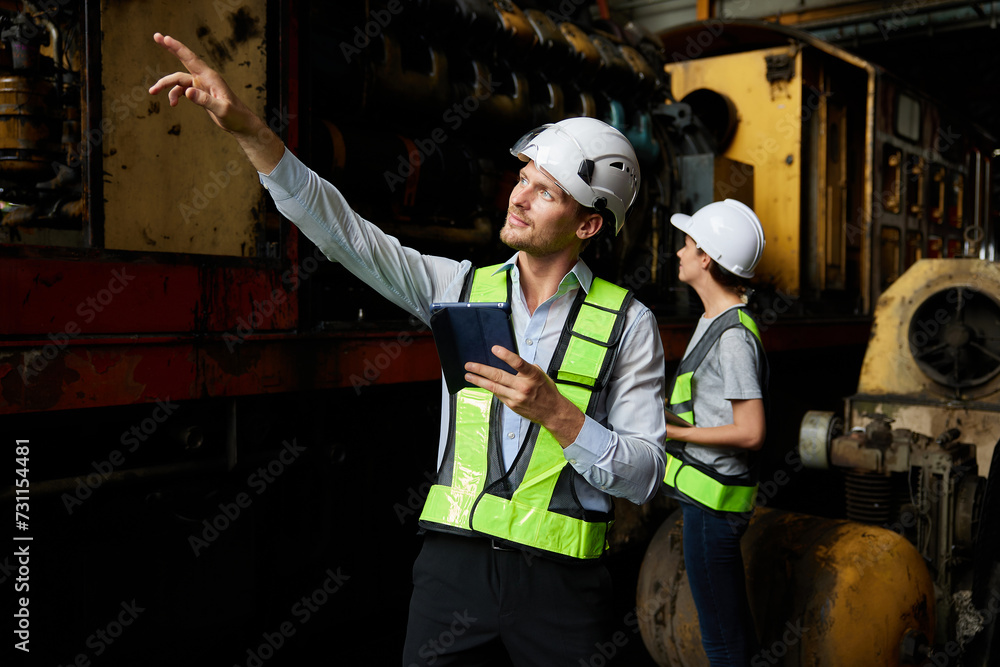 Fototapeta premium engineers or workers checking and pointing to construction train at station