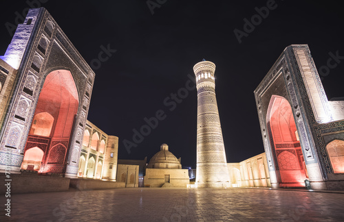 Evening exterior of Kalon Po-i-Kalyan Mosque, Mir Arab madrasasi and Kalyan Minaret in the ancient city of Bukhara in Uzbekistan, night view of madrasah, mosque and minaret photo