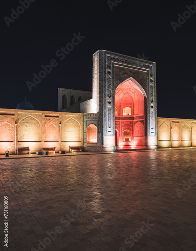 Evening exterior of Kalon Po-i-Kalyan Mosque, Mir Arab madrasasi and Kalyan Minaret in the ancient city of Bukhara in Uzbekistan, night view of madrasah, mosque and minaret photo