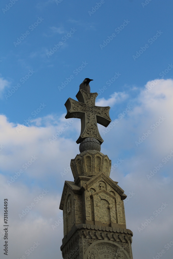 cross on the top of a church and a raven