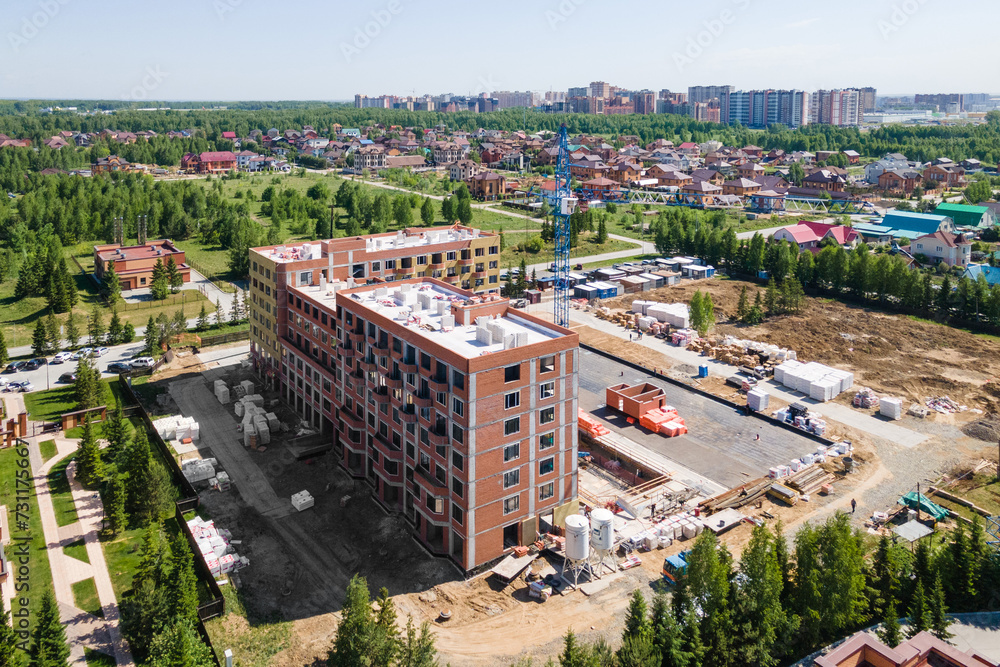 Fototapeta premium the construction site of an apartment building in the summer from a height