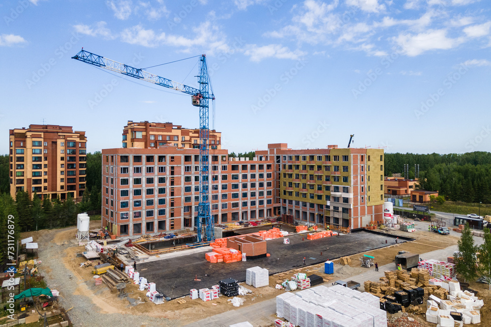 Fototapeta premium the construction site of an apartment building in the summer from a height