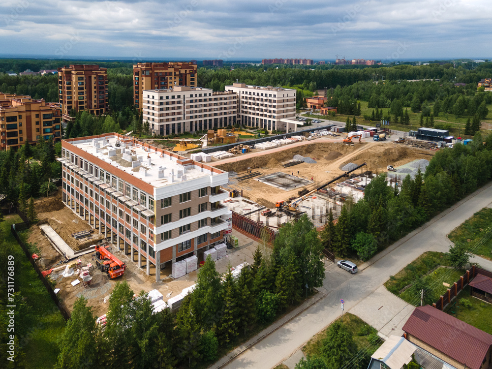 Fototapeta premium the construction site of an apartment building in the summer from a height