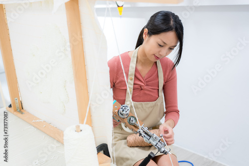 Woman make of tufting carpet at studio photo