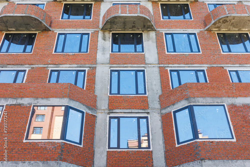Fototapeta premium the construction site of an apartment building in the summer from a height