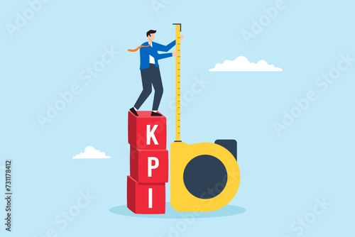 Businessman standing on KPI box and measuring performance
