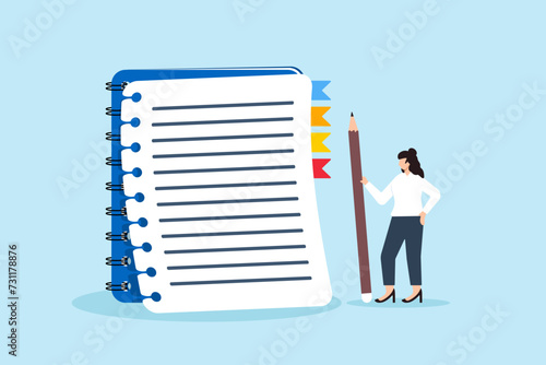 Young woman holding pencil with notebook for taking notes
