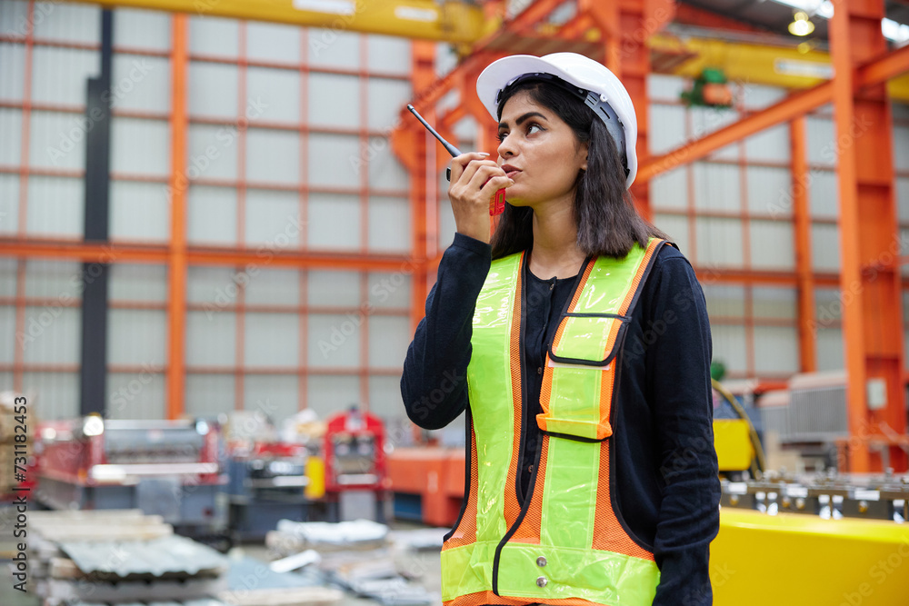worker or engineer talking on walkie talkie in the factory