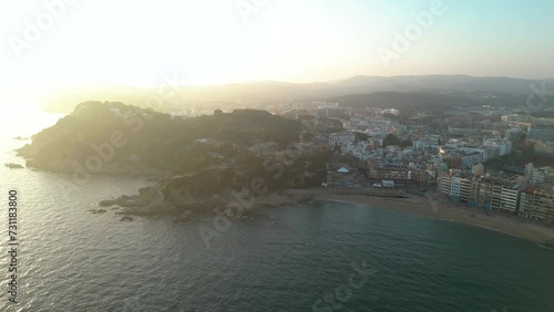 Aerial drone view of Lloret del mar City. View of Castell de Sant Joan and Dona Marinera Statue. At left is Fenals Beach, at right Lloret del Mar beach. In background is the city with old town. Back photo