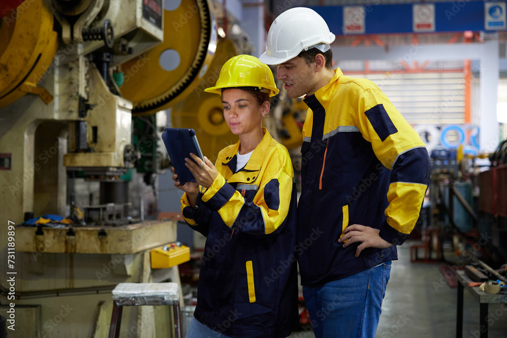 workers or engineers working on tablet and checking product in the metal sheet factory workers or engineers working on tablet and checking product in the metal sheet factory