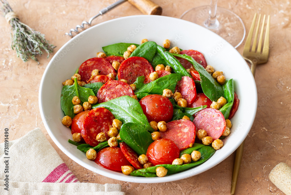 Salad with spinach, sausage, tomatoes and chickpeas. Healthy eating. Diet. Salad with spinach, sausage, tomatoes and chickpeas. Healthy eating. Diet.