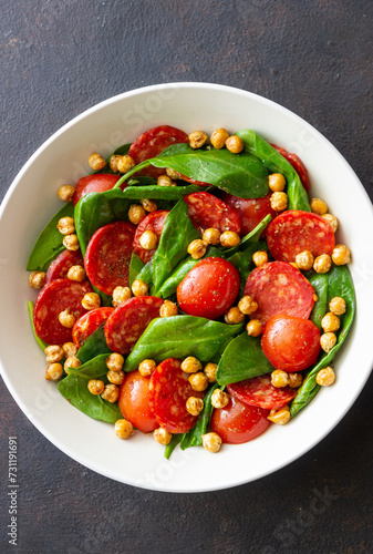 Salad with spinach, sausage, tomatoes and chickpeas. Healthy eating. Diet.